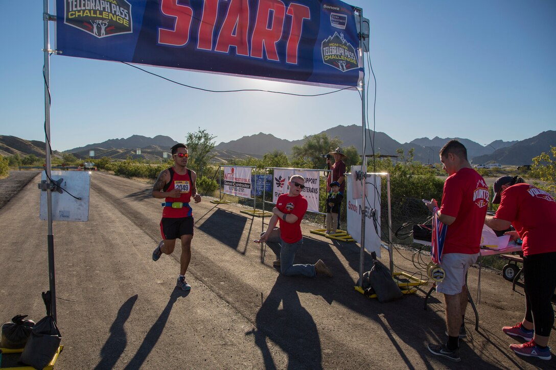 A competitor completes the first annual Telegraph Pass Challenge in Yuma, Ariz., Nov. 3, 2018. The challenge, coordinated by Marine Corps Community Services (MCCS), offered participants the opportunity to compete for first, second, or third place in either a 5 mile run, 5 mile bike route, or both. The course included a "Blue Mile" which is typically the most difficult portion of the racing event being a silent mile. The "Blue Mile" honors and remembers all fallen heroes of the Military, Police, and Fire Department. (U.S. Marine Corps photo by Sgt. Allison Lotz)