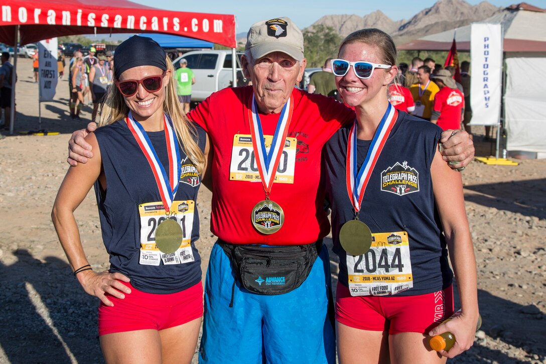 Competitors pose for a group photo after completing the first annual Telegraph Pass Challenge in Yuma, Ariz., Nov. 3, 2018. The challenge, coordinated by Marine Corps Community Services (MCCS), offered participants the opportunity to compete for first, second, or third place in either a 5 mile run, 5 mile bike route, or both. The course included a "Blue Mile" which is typically the most difficult portion of the racing event being a silent mile. The "Blue Mile" honors and remembers all fallen heroes of the Military, Police, and Fire Department. (U.S. Marine Corps photo by Sgt. Allison Lotz)
