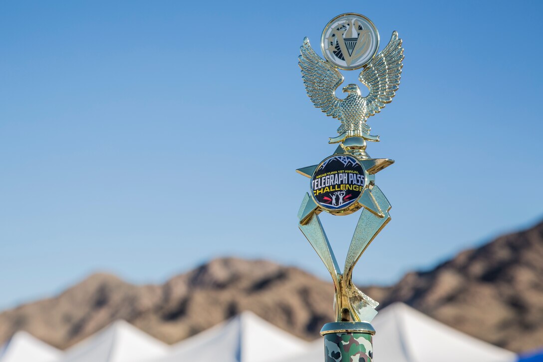 First, second, and third place competitors recieve trophies after competing in the first annual Telegraph Pass Challenge in Yuma, Ariz., Nov. 3, 2018. The challenge, coordinated by Marine Corps Community Services (MCCS), offered participants the opportunity to compete for first, second, or third place in either a 5 mile run, 5 mile bike route, or both. The course included a "Blue Mile" which is typically the most difficult portion of the racing event being a silent mile. The "Blue Mile" honors and remembers all fallen heroes of the Military, Police, and Fire Department. (U.S. Marine Corps photo by Sgt. Allison Lotz)