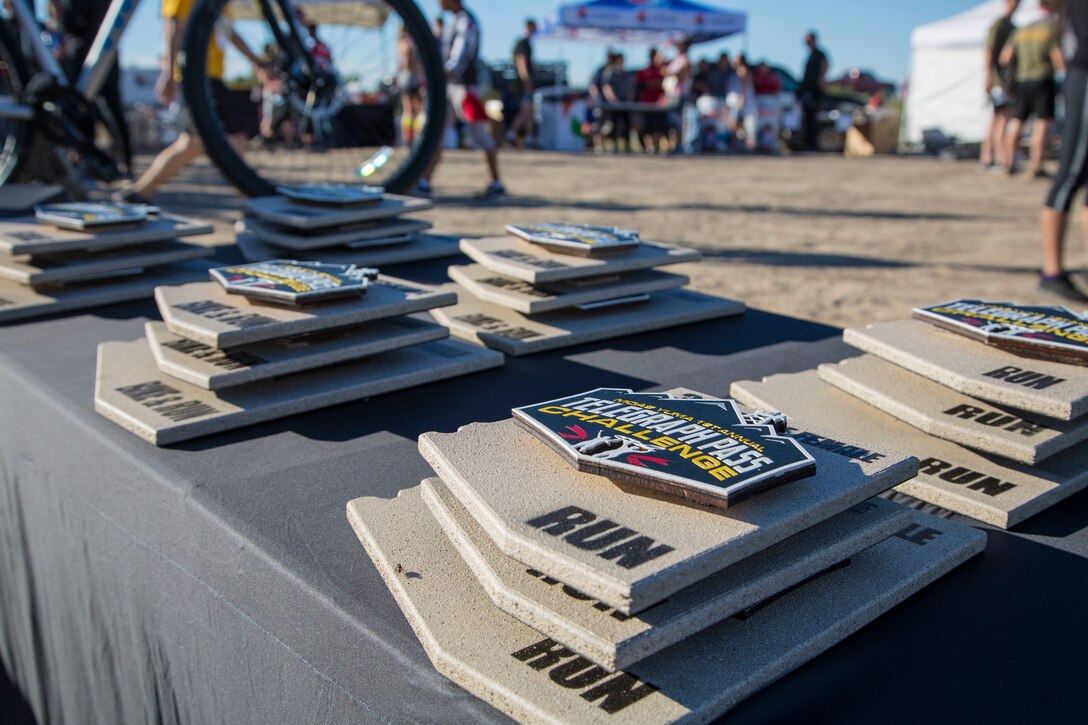First, second, and third place competitors recieve trophies after competing in the first annual Telegraph Pass Challenge in Yuma, Ariz., Nov. 3, 2018. The challenge, coordinated by Marine Corps Community Services (MCCS), offered participants the opportunity to compete for first, second, or third place in either a 5 mile run, 5 mile bike route, or both. The course included a "Blue Mile" which is typically the most difficult portion of the racing event being a silent mile. The "Blue Mile" honors and remembers all fallen heroes of the Military, Police, and Fire Department. (U.S. Marine Corps photo by Sgt. Allison Lotz)