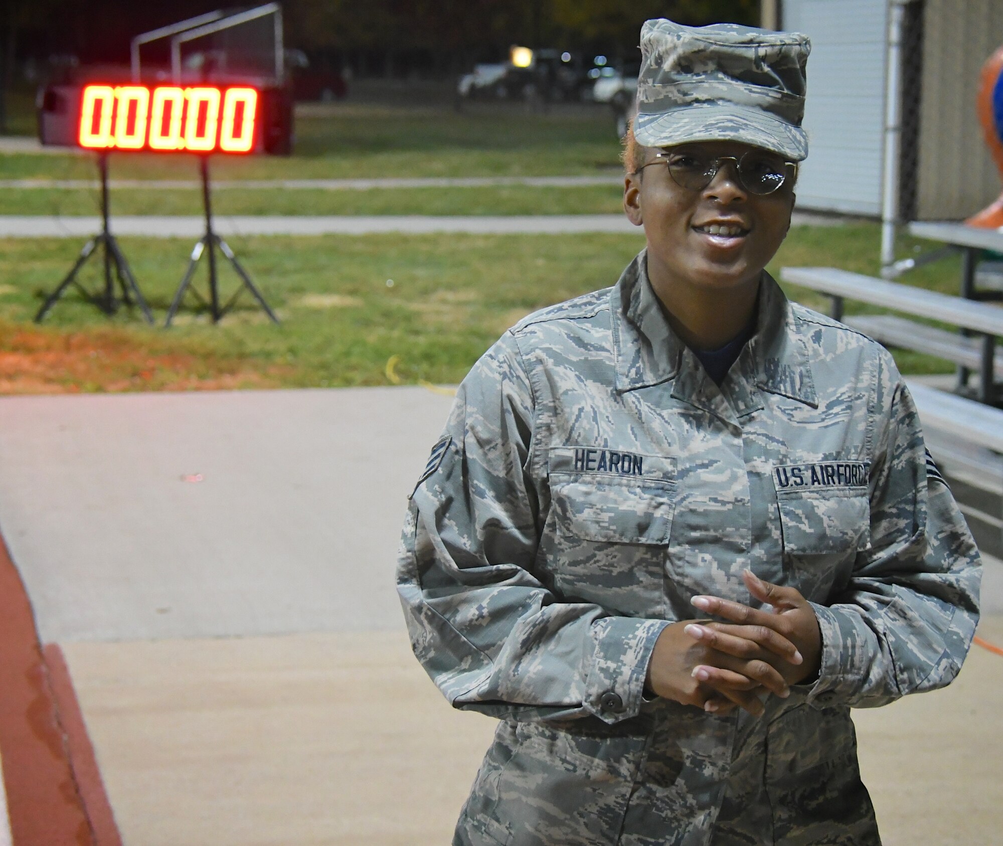 The day starts early before the sun rises as one unit member gets the fitness clock ready.  Explaining the fitness running 1.5 mile test parameters and answering questions from other wing members, Senior Airman Hearon Octavia, far right, prepares to start the timing clock November 4, 2018, at Scott Air Force Base, Ill. She is a member of the 932nd Airlift Wing's Mission Support Group, Services Flight, and she helps get Airmen ready for the various parts of the fitness test each unit training weekend. (U.S. Air Force photo by Lt. Col. Stan Paregien)