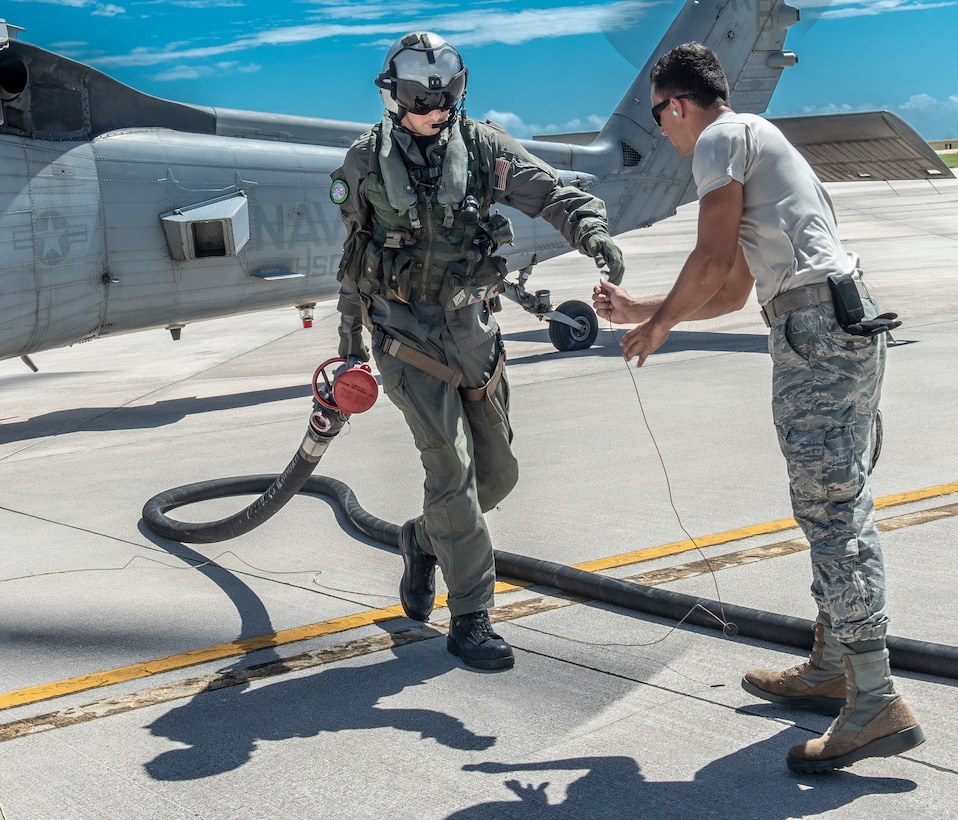 U.S. Air Force Airman 1st Class Brett Heinken, 36th Logistics Readiness Squadron fuels operator prepares to receive a fuel hose after a U.S. Navy Helicopter Sea Combat Squadron 25 member refuels in Saipan, Commonwealth of the Northern Mariana Islands Nov. 5, 2018.