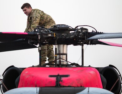 U.S. Army 1st Lt. Vincent Sherrill, a UH-60M Black Hawk helicopter pilot with the California Army National Guard's 1st Assault Helicopter Battalion, 140th Aviation Regiment, conducts a preflight inspection of the helicopter, Nov. 16, 2018, at Sacramento Mather Airport in Mather, California, before flying water bucket missions to help contain the deadly Camp Fire burning in Butte County.