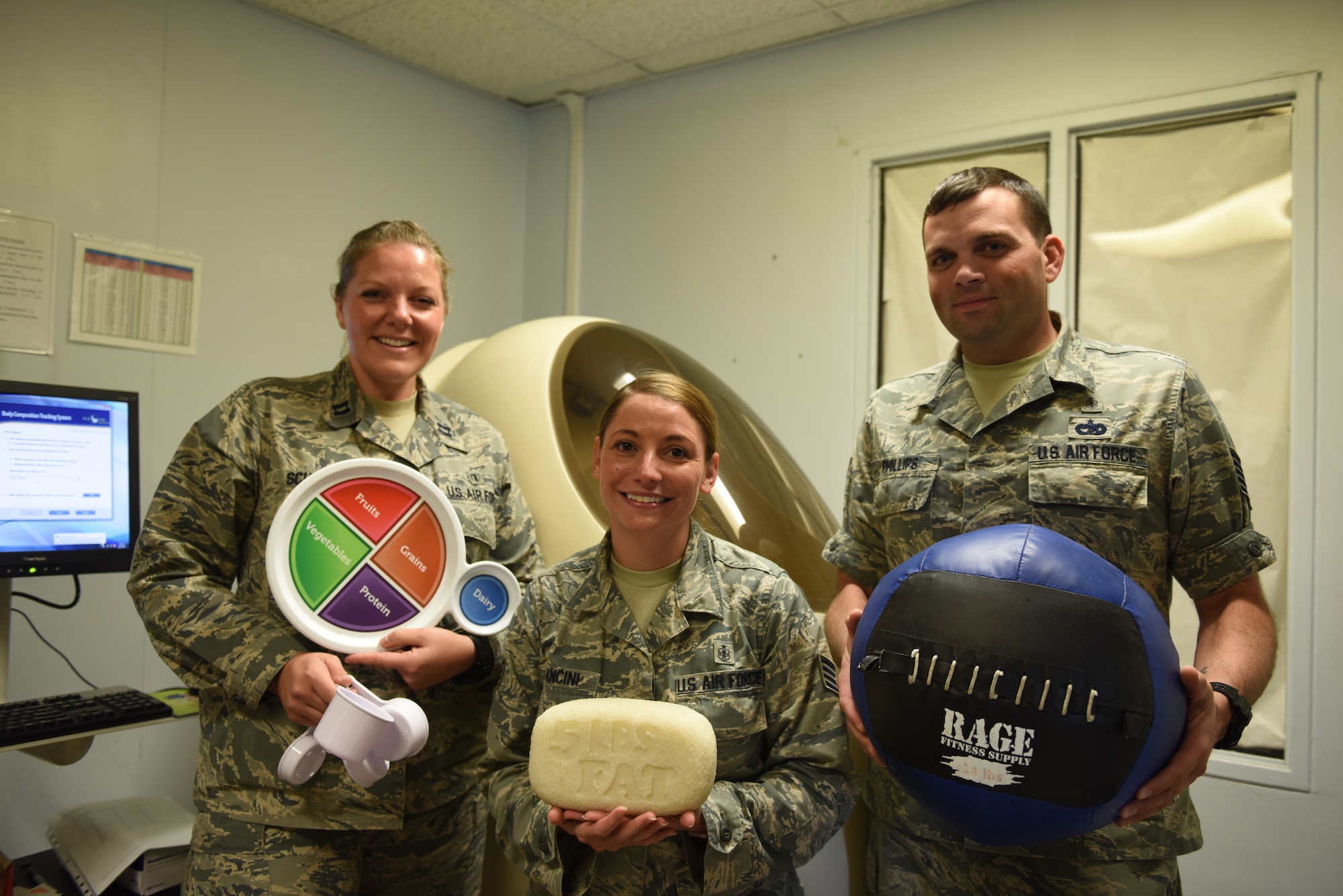 U.S. Air Force Capt. Abigail Schutz, Staff Sgt. Jennifer Mancini and Tech. Sgt. Brian Phillips, pose for a photo in front of the Bod Pod at Incirlik Air Base.