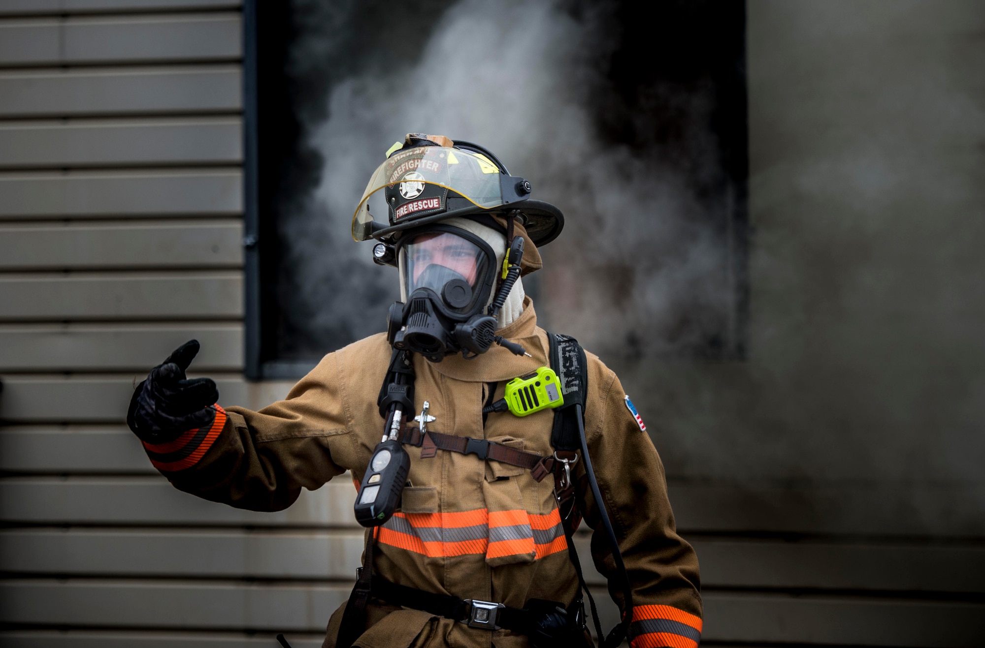 U.S. Air Force Airman 1st Class Austin Perry, 20th Civil Engineer Squadron, firefighter signals a fellow firefighter at Shaw Air Force Base, S.C., Nov. 20, 2018.