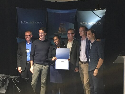 Air Force Research Laboratory Tech Engagement Office members present CrowdAI with a $25,000 first prize certificate at the Hyperspace Challenge Nov. 15 in Albuquerque at the Lobo Rainforest Building.  (Left to Right) Gabe Mounce, AF Space Accelerator program manager; Cliff Massey, business development lead at CrowdAI; Devaki Raj, chief executive officer and founder of CrowdAI; Matt Fetrow, TEO director; TJ Cook, executive director of ABQid; and Nicolas Borensztein, founder and chief technology officer of CrowdAI. (Courtesy photo)