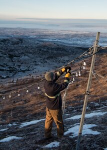 U.S. Air Force Staff Sgt. Steven Andersen, 773d Civil Engineer Squadron electrical shop exterior electric noncommissioned officer in charge, examines wiring on the brightly lit star placed on the side of Mount Gordon Lyon at Joint Base Elmendorf-Richardson, Alaska, Nov. 23, 2018. The star spans more than 300 feet and is located in an area just below the old U.S. Army Air Defense Command Nike Hercules missile battery – one of three which defended the Anchorage bowl during the Cold War. Since 2010, Airmen from the 773d CES electrical shop have assumed caretaking responsibility for the stars location.
