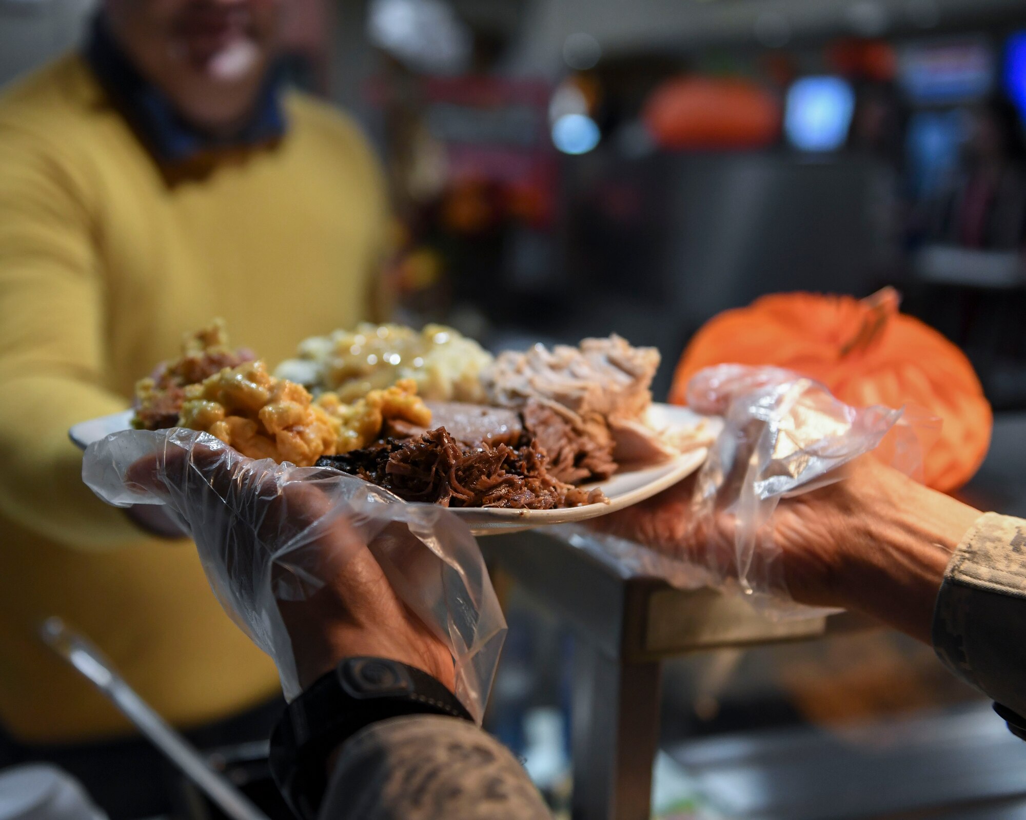 U.S. Air Force Lt. Col. Tommy Marshall, 633rd Communications Squadron commander, gives a Crossbow Dining Facility patron a Thanksgiving Day meal at Joint Base Langley-Eustis, Virginia, Nov. 22, 2018.