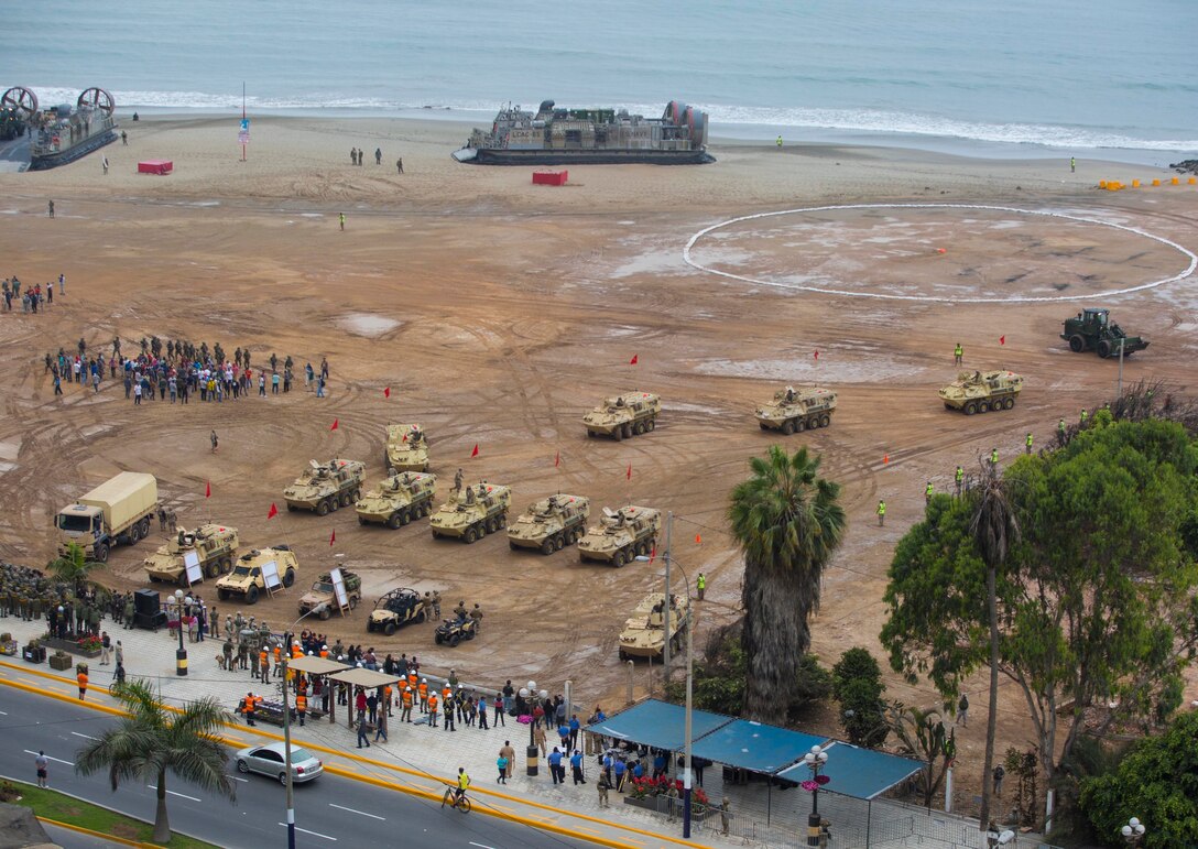 U.S. Navy Landing Craft, Air Cushioned hovercraft from the USS Somerset (LPD 25), along with U.S. Marines from Special Purpose Marine Air-Ground Task Force - Peru and Peruvian Naval Infantry Light Armored Vehicles take position on the beach.