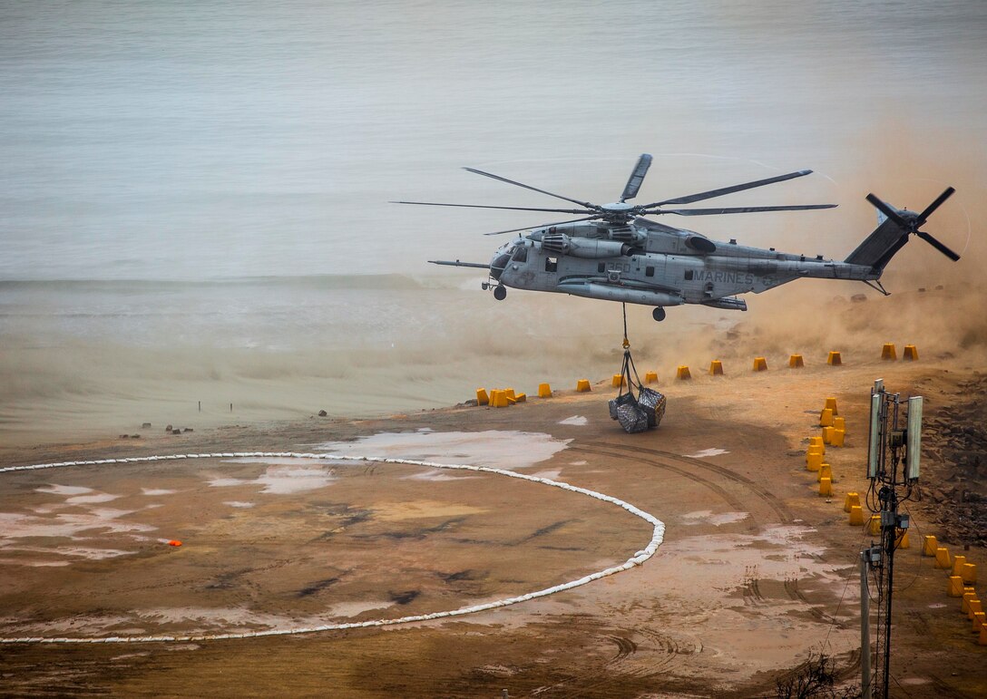 A U.S. Marine Corps CH-53E Super Stallion transports food and water during a humanitarian assistance and disaster relief demonstration between U.S. Marines with Special Purpose Marine Air-Ground Task Force - Peru and Peruvian naval forces Nov. 24, 2018, near Lima, Peru.