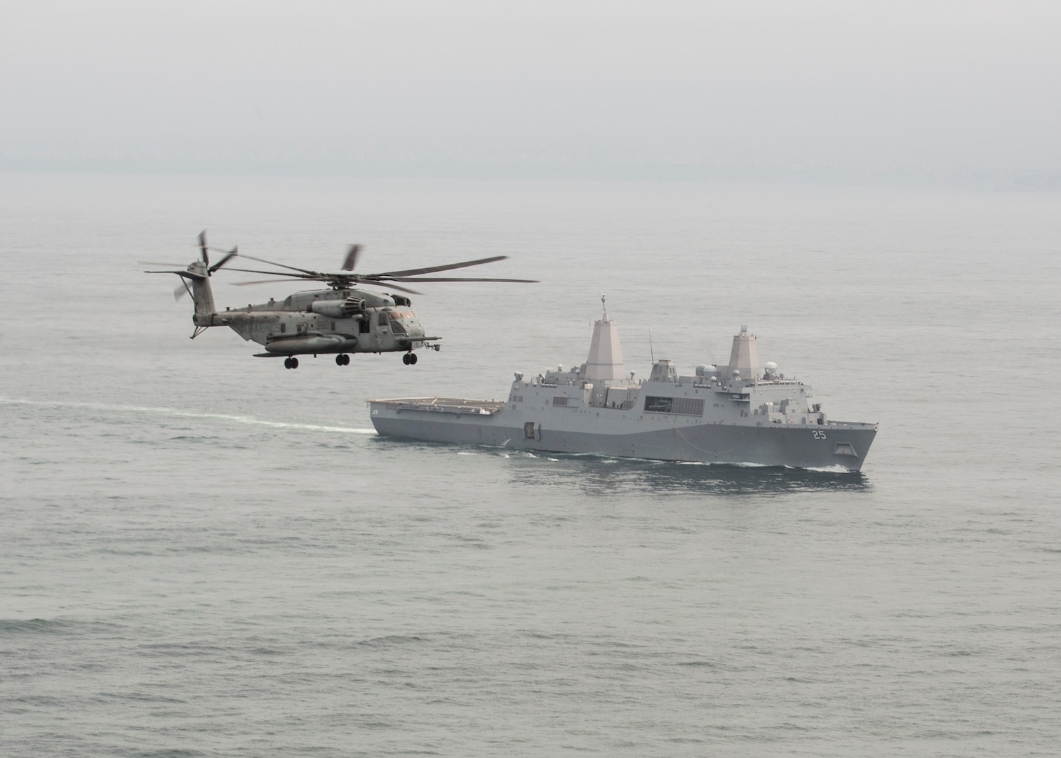 A U.S. Marine Corps CH-53E Super Stallion with Marine Heavy Helicopter Squadron 462, Special Purpose Marine Air-Ground Task Force - Peru, flies above the U.S. Navy San Antonio-class amphibious transport dock ship USS Somerset (LPD 25) during a humanitarian assistance and disaster relief exercise off of the coast of Chorrillos Beach, near Lima, Peru, Nov. 24, 2018.