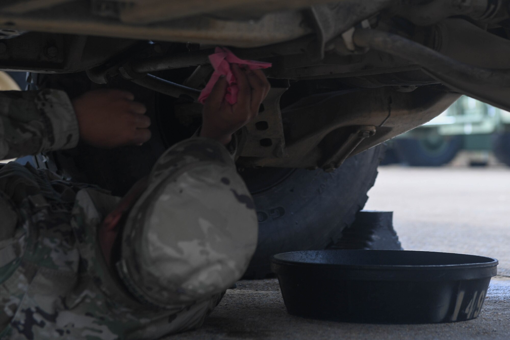 U.S. Army Spc. Takory Coleman, 149th Seaport Operations Company, 10th Transportation Battalion, 7th Trans. Brigade (Expeditionary) transportation management coordinator, checks fuel lines on a HUMVEE at Joint Base Langley-Eustis, Virginia, Nov. 19, 2018. During preventative maintenance checks, Coleman checked the oil, fuel lines, lights and the engine. (U.S. Air Force photo by Senior Airman Derek Seifert)