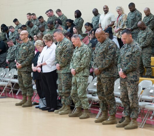 U.S. Marines assigned to U.S. Marine Corps Forces Command and distinguished guests stand during the invocation during a ceremony where Camp Allen was rededicated as Camp Elmore in honor of Pfc. George W. Elmore, Nov. 27, 2018, at Camp Elmore, Norfolk, Virginia. Elmore, while serving as an automatic rifleman, was killed in combat Feb. 26, 1951, and was posthumously awarded the Navy Cross. Camp Elmore is the first Marine Corps installation to be named in honor of an enlisted Marine. (Official U.S. Marine Corps photo by Chris Jones/Released)