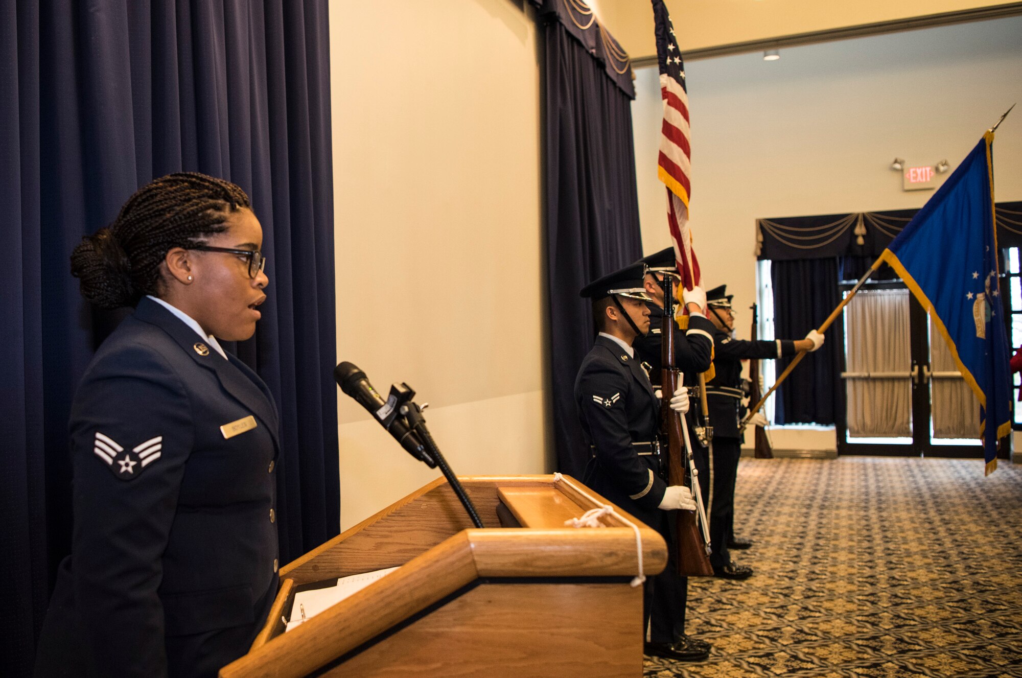 Senior Airman Claire Boyles, 436th Logistics Readiness Squadron, sings the national anthem as the Dover Air Force Base Honor Guard presents the colors at the beginning of the annual State of the Base Nov. 19, 2018, at Dover AFB, Del. The event was hosted by the Central Delaware Chamber of Commerce and provided an opportunity to educate and inform community members and leaders on the economic impact the base has on the surrounding community. (U.S. Air Force photo by Airman 1st Class Zoe M. Wockenfuss)