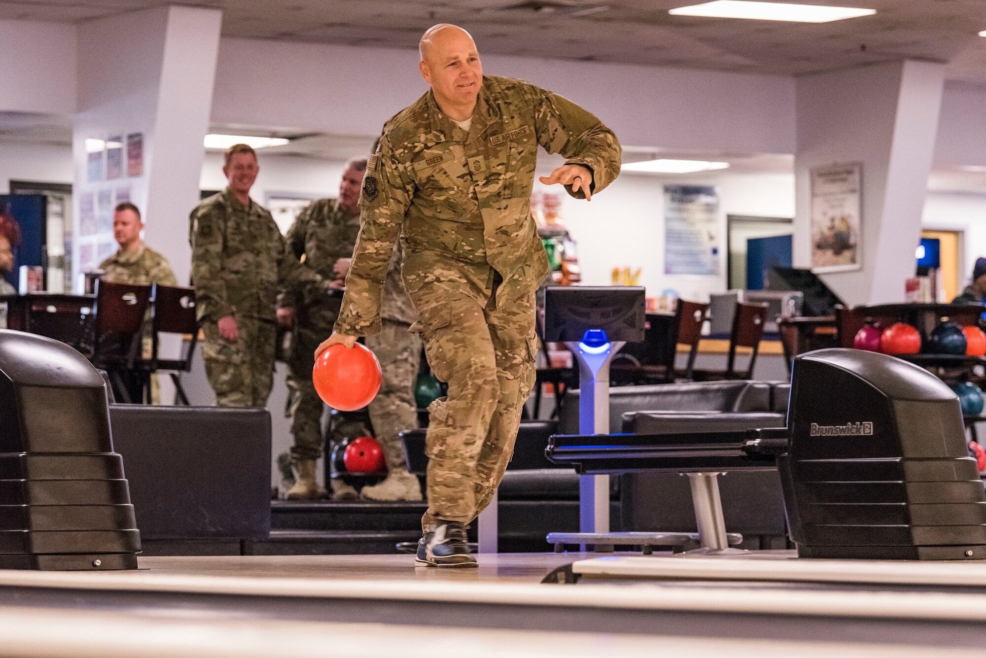 Chief Master Sgt. Anthony Green, left, 436th Airlift Wing command chief, approaches his lane for a shot during a bowling grudge match Nov. 16, 2018, at the Eagle Lanes on Dover Air Force Base, Del. Col. Joel Safranek, 436th Airlift Wing commander, challenged Green to the grudge match after losing to Green during the 436th AW Leadership Off-Site back in September. Green won two out of the three games played during the grudge match. (U.S. Air Force photo by Roland Balik)