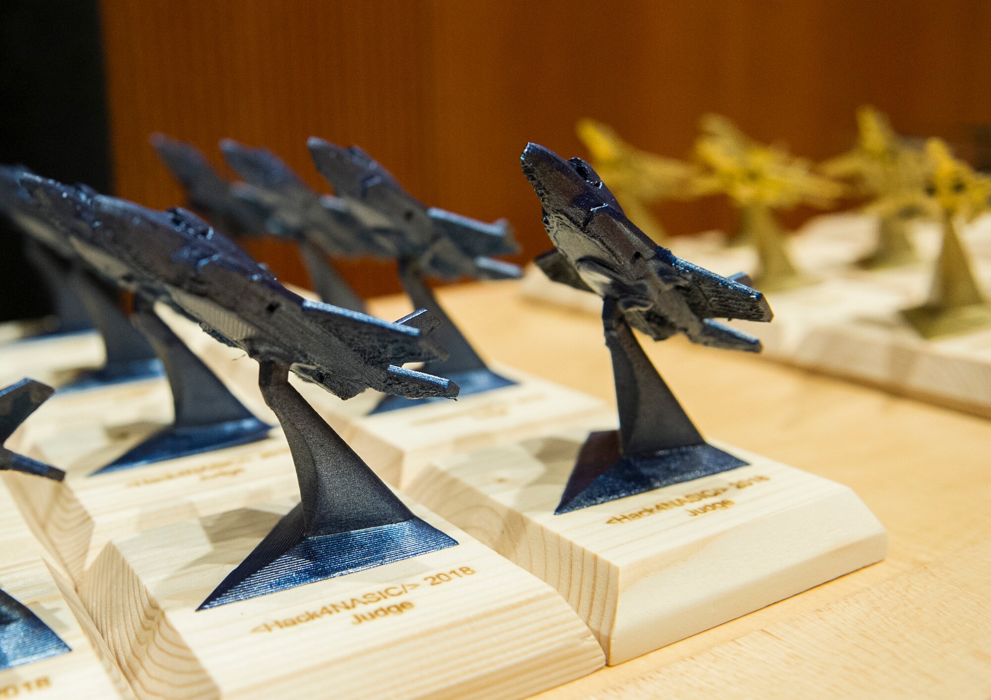 3D-printed trophies sit on a table to be awarded during the Hack4NASIC judging Oct. 12, 2018. The trophies were awarded to the winners of Hack4NASIC as well as to those in each category. (U.S. Air Force photo by Senior Airman Michael Hunsaker)