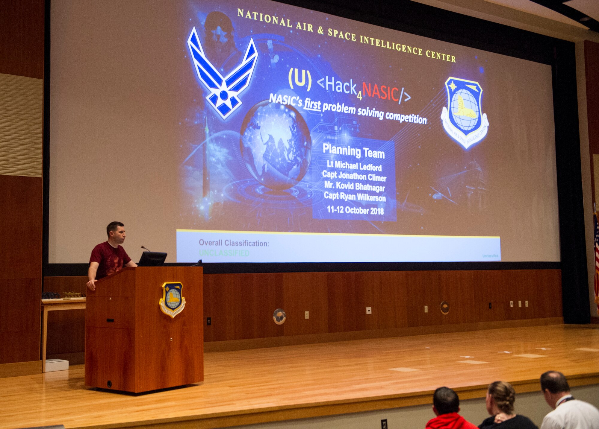 Capt. Jonathan Climer, Integrated C4ISR Analysis Squadron Chief Engineer, introduces the audience to the Hack4NASIC presentations, Oct. 12, 2018. This year was the inaugural year for the event with the hopes of improving NASIC in the years to come. (U.S. Air Force photo by Senior Airman Michael Hunsaker)