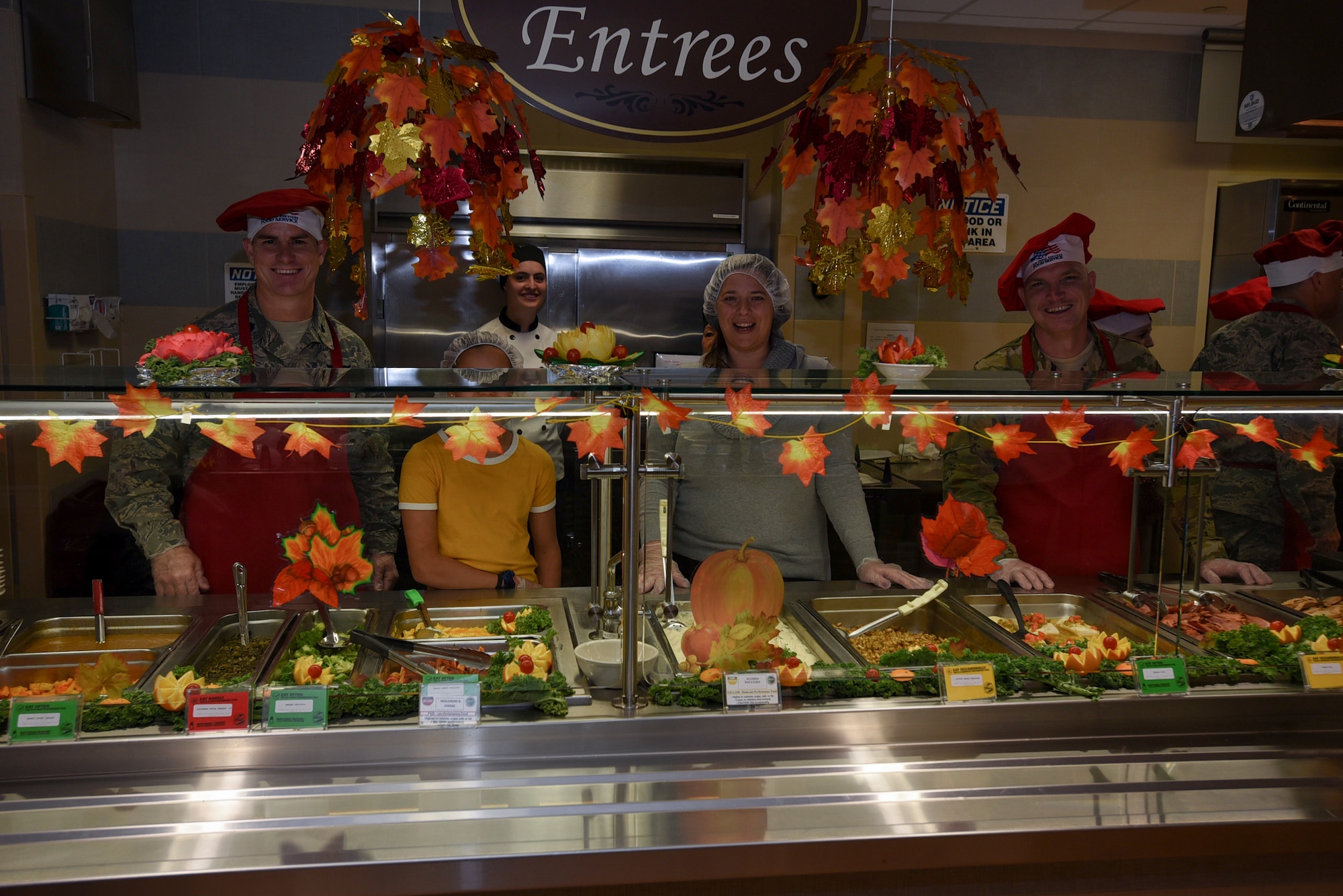 Service members and their families serve food during Thanksgiving dinner on Joint Base McGuire-Dix-Lakehurst, New Jersey, Nov. 22, 2018. Joint Base leadership and their families took turns serving food to the service members who were unable to travel home for the holiday. (U.S. Air Force photo by Airman 1st Class Ariel Owings)