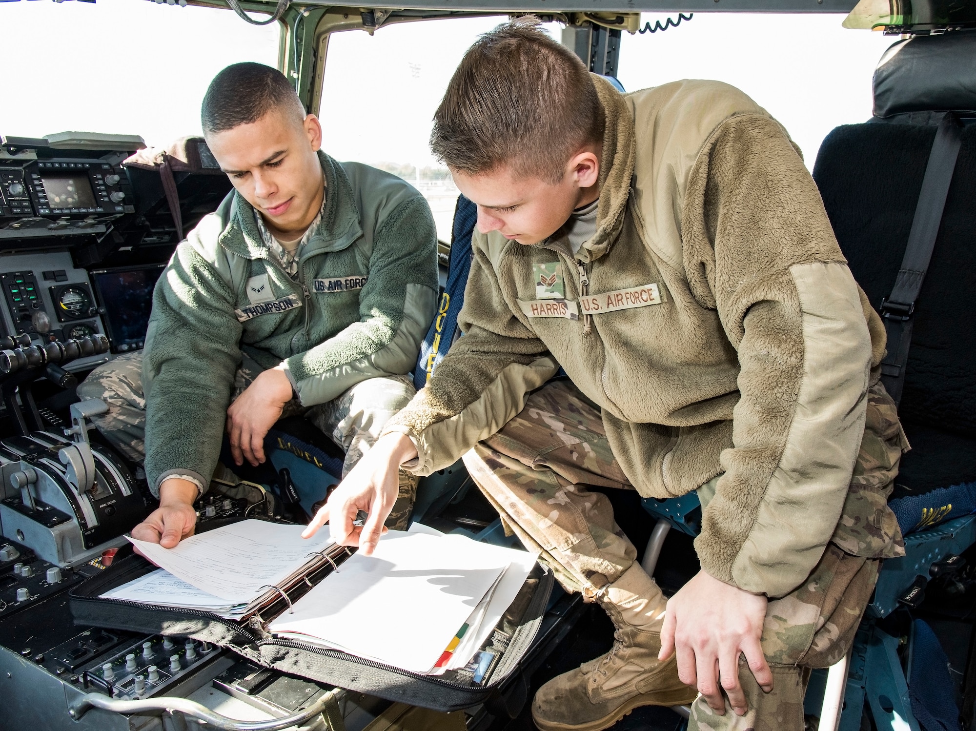 Senior Airman Victor Harris, right, Dedicated Crew Chief, and Airman 1st Class Jason Thompson, left, Assistant DCC, both assigned to the 736th Aircraft Maintenance Squadron, review the aircraft forms of a C-17 Globemaster III Nov. 21, 2018, at Dover Air Force Base, Del. Harris and Thompson were formally appointed as DCC and ADCC of their assigned aircraft during a formal induction ceremony held Nov. 16. (U.S. Air Force photo by Roland Balik)