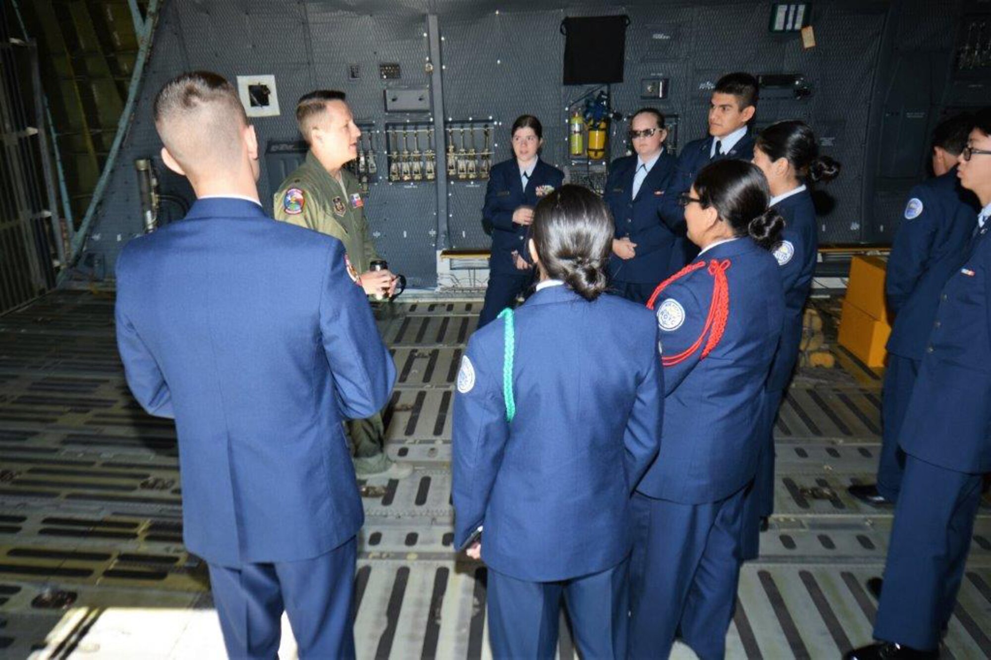 Inside the cargo compartment of the C-5M Super Galaxy, Nov. 16, 2018, Maj. Caleb Rasmussen with the 68th Airlift Squadron, discusses the type of cargo and payload the C-5M Super Galaxy can transport, to Porter High School Air Force Junior Reserve Officers’ Training Corps cadets, from Porter, Texas, during a two-day tour of Joint Base San Antonio-Lackland, Texas.