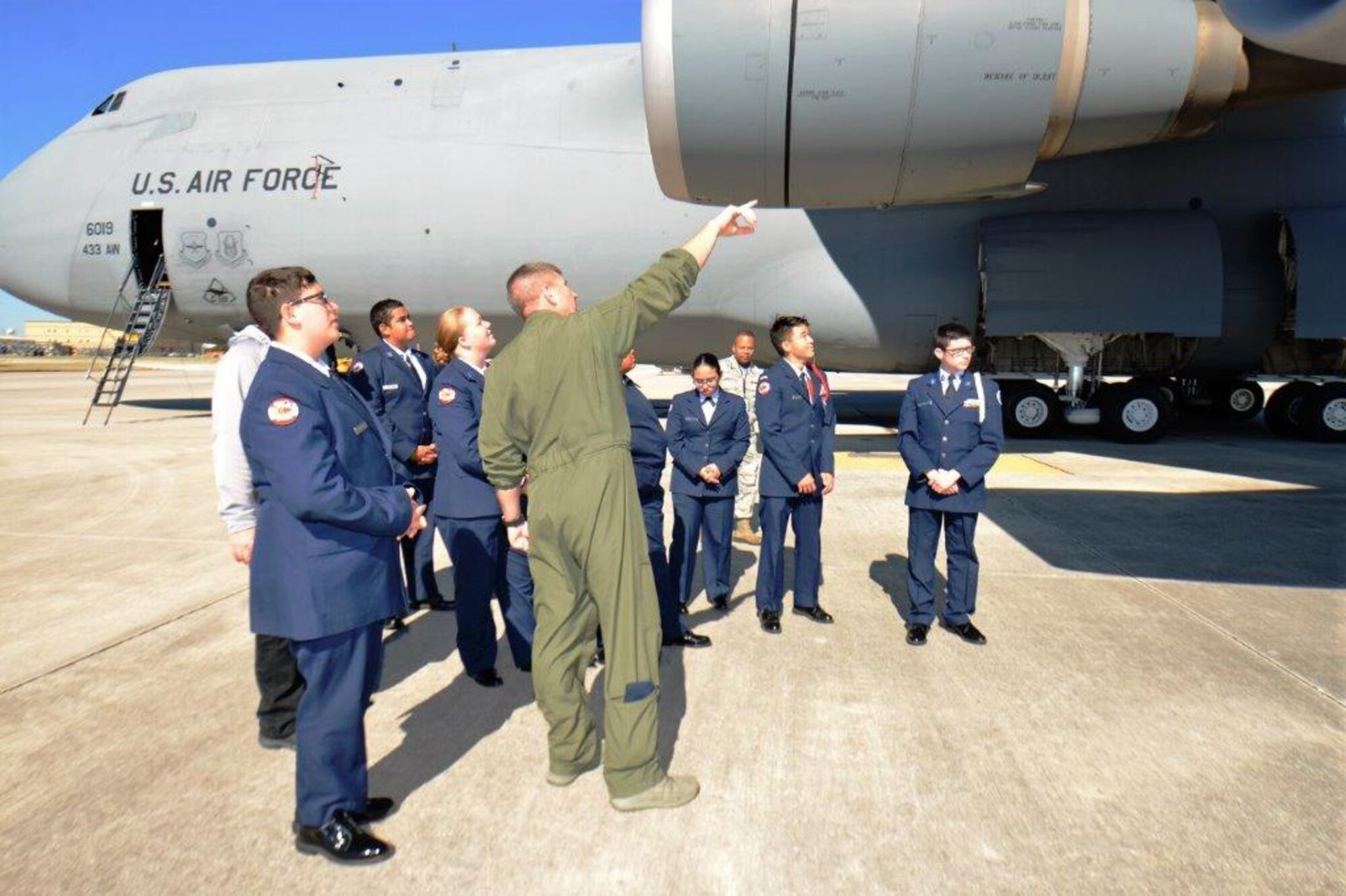 Flight Engineer Tech. Sgt. Ryan Lohrer with the 68th Airlift Squadron, Joint Base San Antonio-Lackland, gives a walk-around tour of the C-5M Super Galaxy, Nov. 16, 2018, to Porter High School Air Force Junior Reserve Officers’ Training Corps cadets, from Porter, Texas.