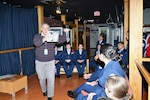 Command Curator Rudy Purificato gives a guided tour with photos at the U.S. Air Force Airman Heritage Museum to Porter High School Air Force Junior Reserve Officers’ Training Corps cadets, Nov. 16, 2018 during a two-day tour of Joint Base San Antonio-Lackland.