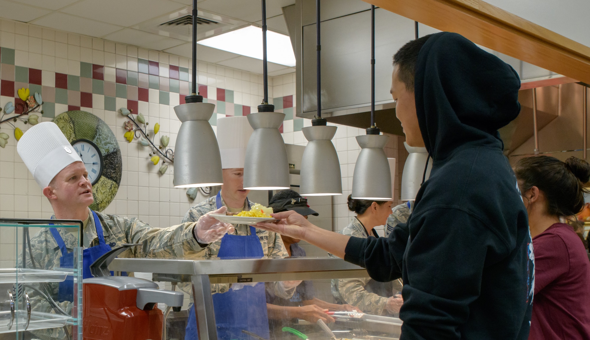 U.S. Air Force Master Sgt. Richard Stites, 334th Training Squadron first sergeant, serves Thanksgiving Day lunch to Airman 1st Class Maxim Tyan, 334th TRS student, inside the Azalea Dining Facility at Keesler Air Force Base, Mississippi, Nov. 22, 2018. It is tradition at Keesler for commanders, first sergeants and superintendents to take time out of their holiday to serve a Thanksgiving meal to technical training and permanent party Airmen. (U.S. Air Force photo by Andre' Askew)