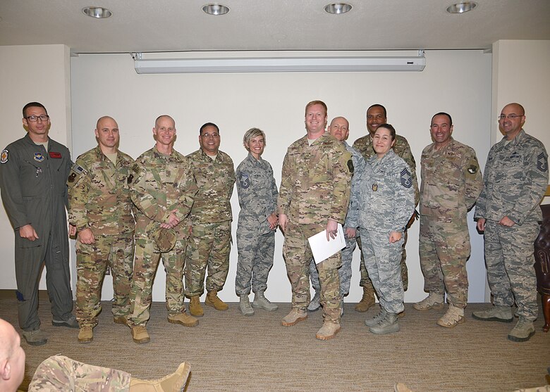 Tech. Sgt. Casey Spang, 71st Special Operations Squadron CV-22 evaluator special mission aviator and members of Kirtland Chiefs' Group pose for a group photo at Kirtland, Nov. 8, 2018. Spang was recognized for above and beyond efforts in training and evaluating students, including a monthly average of 18 hours of in-flight instruction. (U.S. Air Force photo by Todd Berenger)