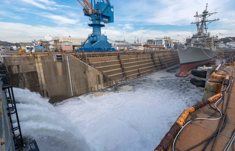 YOKOSUKA, Japan (Nov. 27, 2018) The Arleigh Burke-class guided missile destroyer USS John S. McCain (DDG 56) prepares to undock as a dry dock is flooded in order to test the ship's integrity. McCain is departing the dock after an extensive maintenance period in order to sustain the ship's ability to serve as a forward-deployed asset in the U.S. 7th Fleet area of operations.