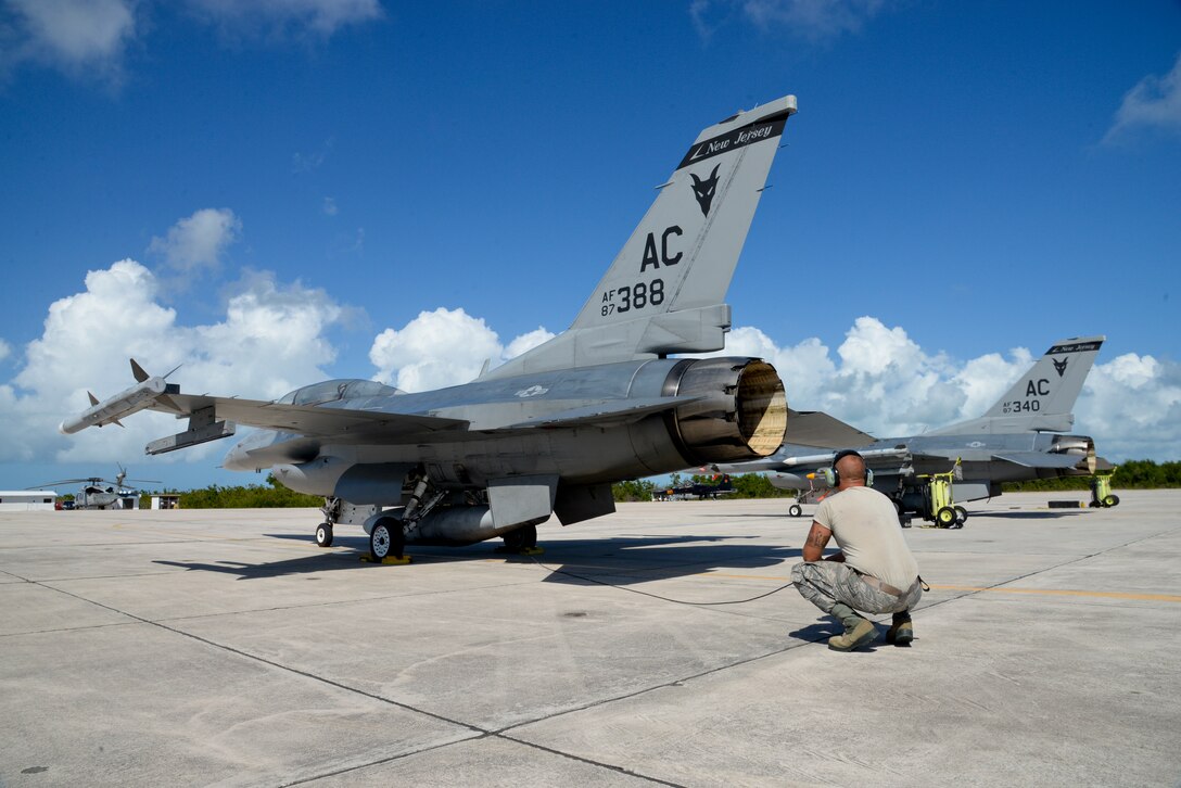 A picture of U.S. Air Force Tech. Sgt. Anthony Falcone, crew chief with the 177th Fighter Wing, verifying flight control surface checks on an F-16D Fighting Falcon.