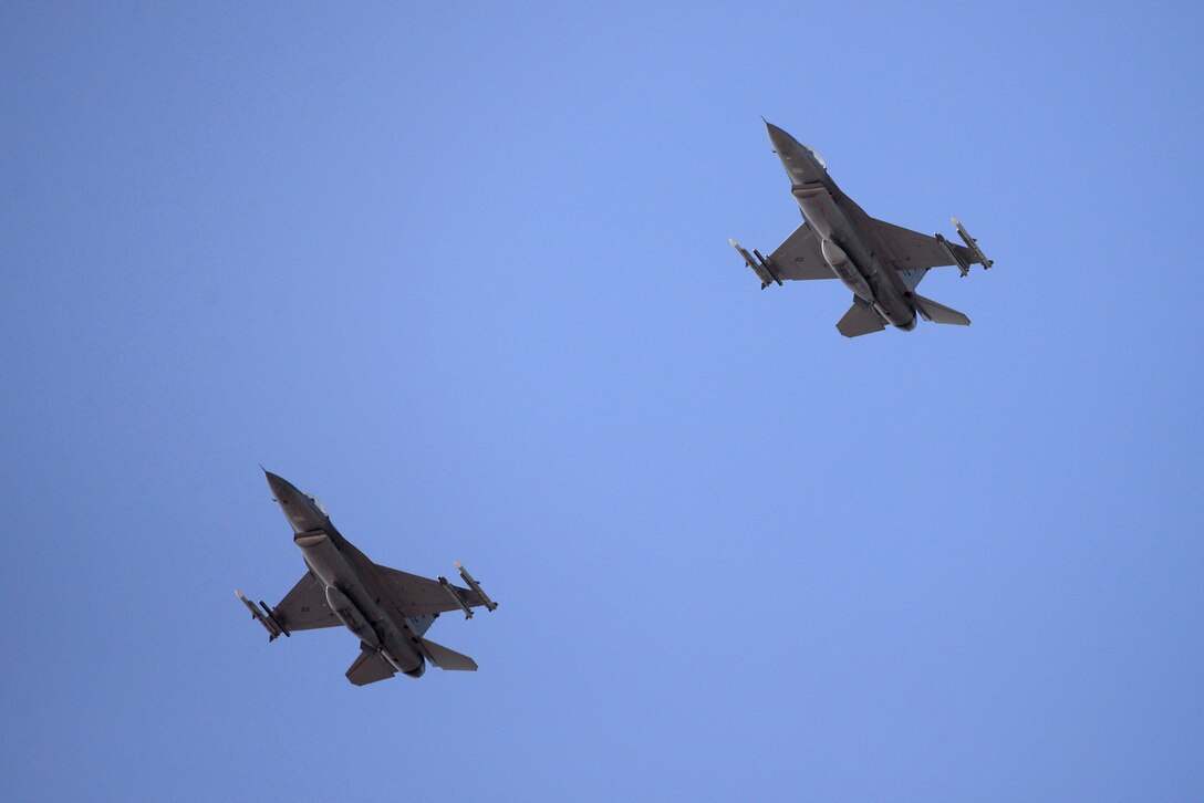 A picture of two U.S. Air Force F-16C Fighting Falcons flying over Boca Chica Naval Air Station, Florida.