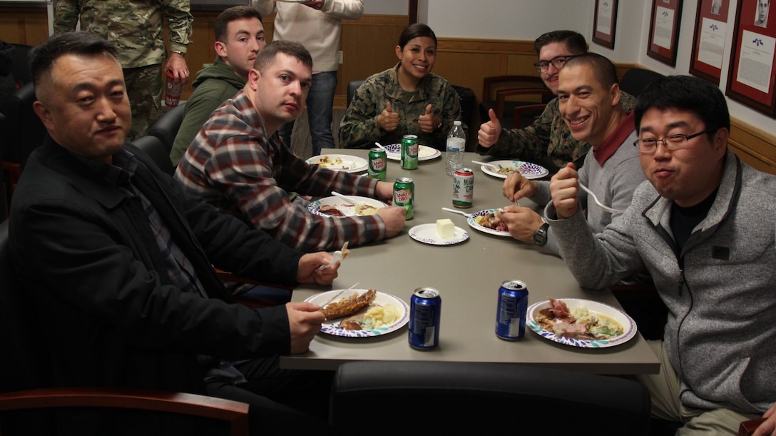 CAMP HUMPHREYS, Republic of Korea - U.S. Marine Corps Forces Korea Marines enjoy their Thanksgiving Meal provided by the spouses of Marines from across the combined joint services here, Nov. 26.  The Marine spouses wanted the Marines to have a nice home cooked meal as a team before departing for the holiday. (Official U.S. Marine Corps photos by Capt. John Parry/Released)