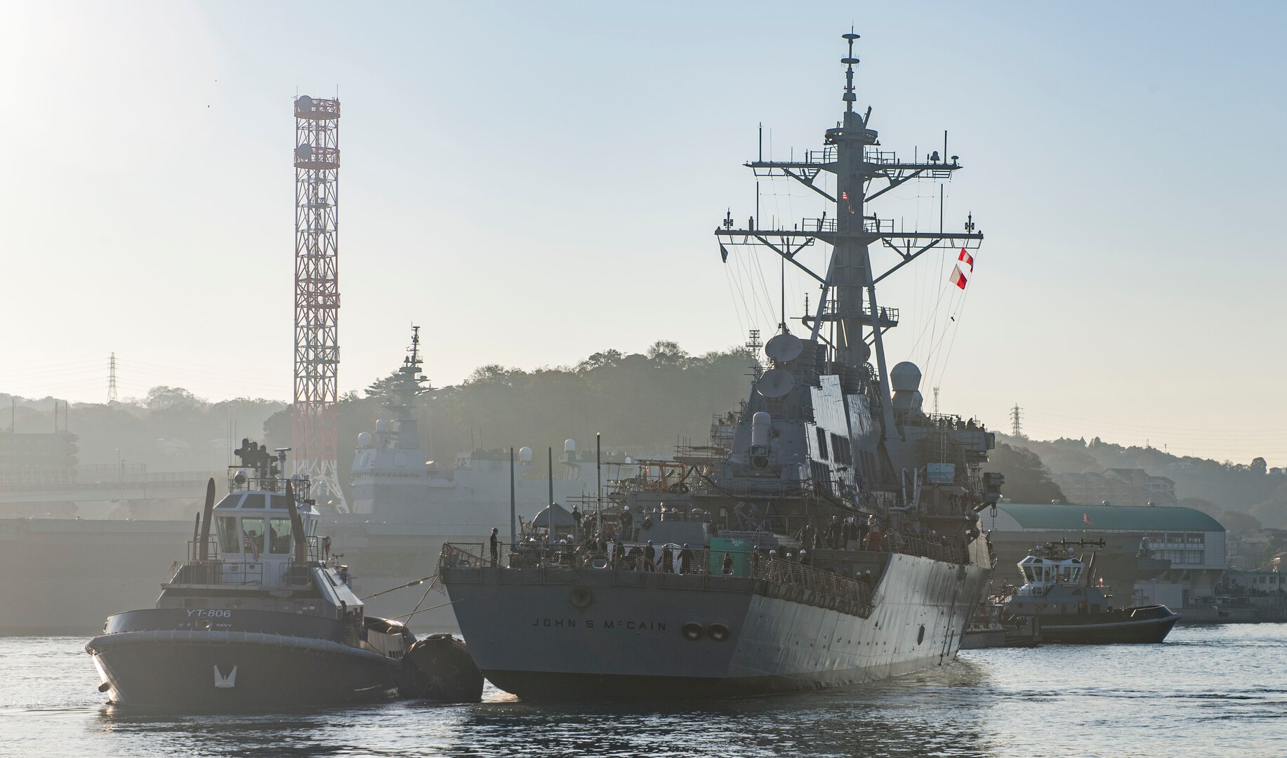 YOKOSUKA, Japan (Nov. 27, 2018) The Arleigh Burke-class guided missile destroyer USS John S. McCain (DDG 56) is pulled towards a pier after departing from a dry dock at Fleet Activities Yokosuka. McCain is departing the dock after an extensive maintenance period in order to sustain the ship's ability to serve as a forward-deployed asset in the U.S. 7th Fleet area of operations.