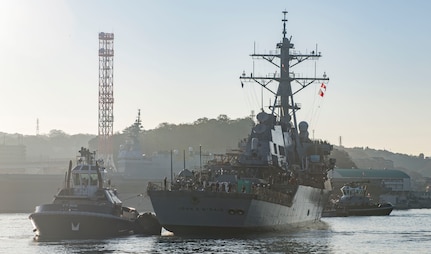 YOKOSUKA, Japan (Nov. 27, 2018) The Arleigh Burke-class guided missile destroyer USS John S. McCain (DDG 56) is pulled towards a pier after departing from a dry dock at Fleet Activities Yokosuka. McCain is departing the dock after an extensive maintenance period in order to sustain the ship's ability to serve as a forward-deployed asset in the U.S. 7th Fleet area of operations.