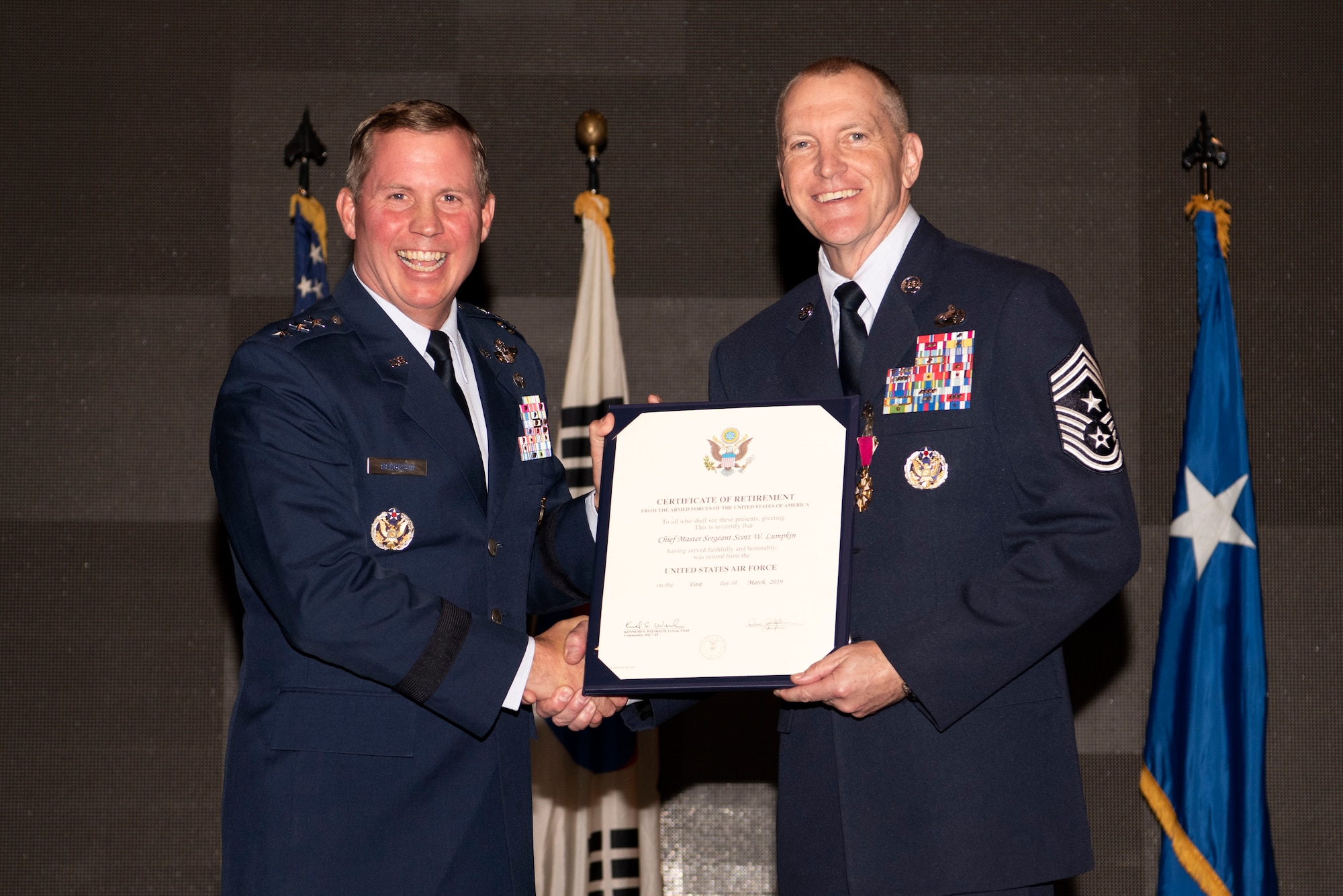 Lt. Gen. Thomas Bergeson, U.S. Central Command deputy commander and former Seventh Air Force commander, poses with Chief Master Sgt. Scott Lumpkin, Seventh Air Force command chief, during his retirment ceremony Nov. 16, 2018 at Osan Air Base, Republic of Korea. During his 30 years in the Air Force, Lumpkin served at 17 different locations which included four assignments to Osan. (U.S. Air Force photo by Senior Airman Kelsey Tucker)