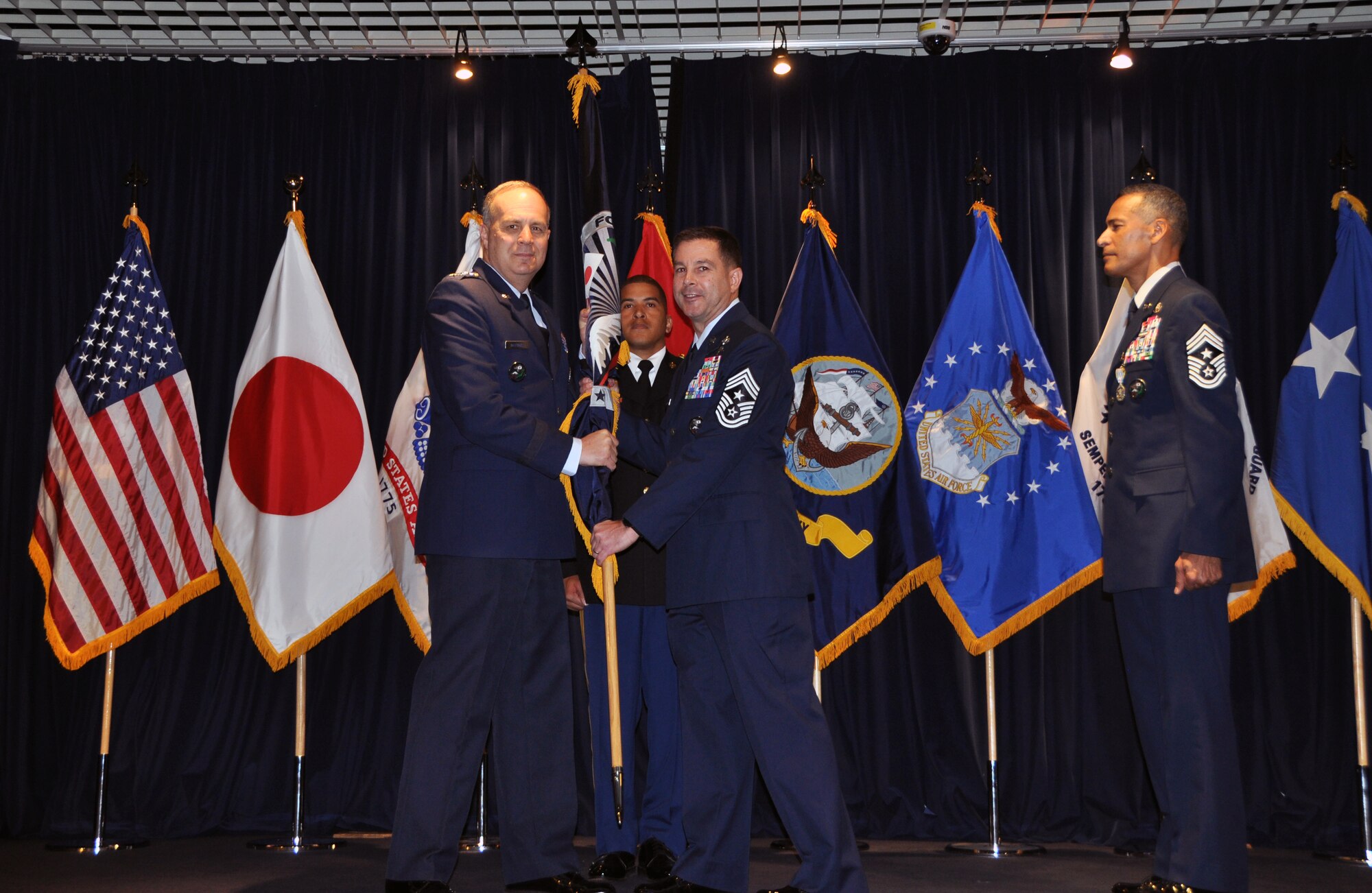 Chief Master Sgt. Terrence Greene (right), who served dual-hatted as the U.S. Forces Japan Senior Enlisted Leader and 5th Air Force Command Chief, relinquished his responsibilities to Chief Master Sgt. Richard. Winegardner Jr., who will serve as the USFJ SEL. USFJ and 5th AF commander Lt. Gen. Jerry Martinez (left) presided over the Change of Responsibility ceremony. This is the first time a senior enlisted leader will serve in each position.