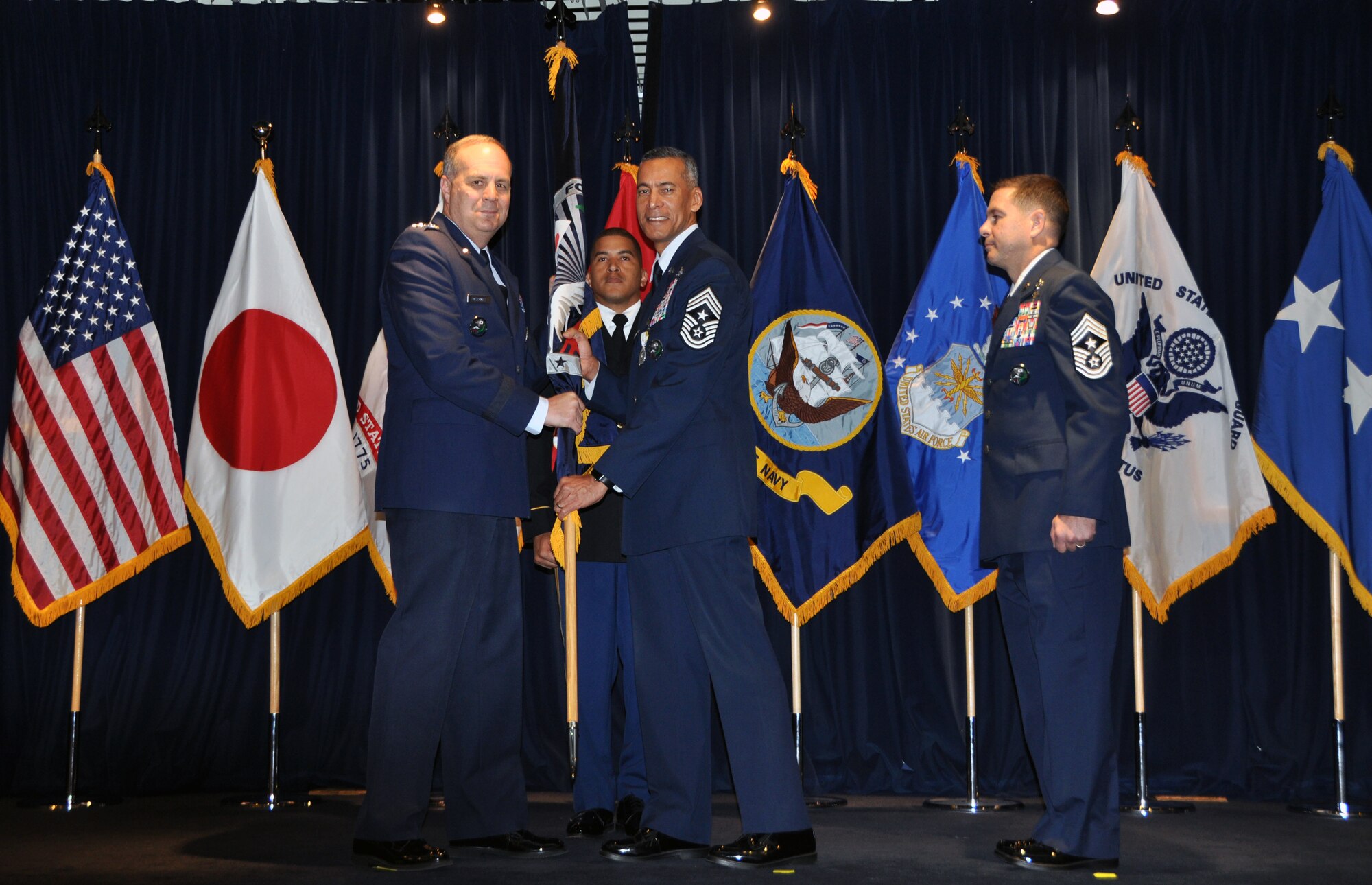 Chief Master Sgt. Terrence Greene (right), who served dual-hatted as the U.S. Forces Japan Senior Enlisted Leader and 5th Air Force Command Chief, relinquished his responsibilities to Chief Master Sgt. Richard. Winegardner Jr., who will serve as the USFJ SEL. USFJ and 5th AF commander Lt. Gen. Jerry Martinez (left) presided over the Change of Responsibility ceremony. This is the first time a senior enlisted leader will serve in each position.