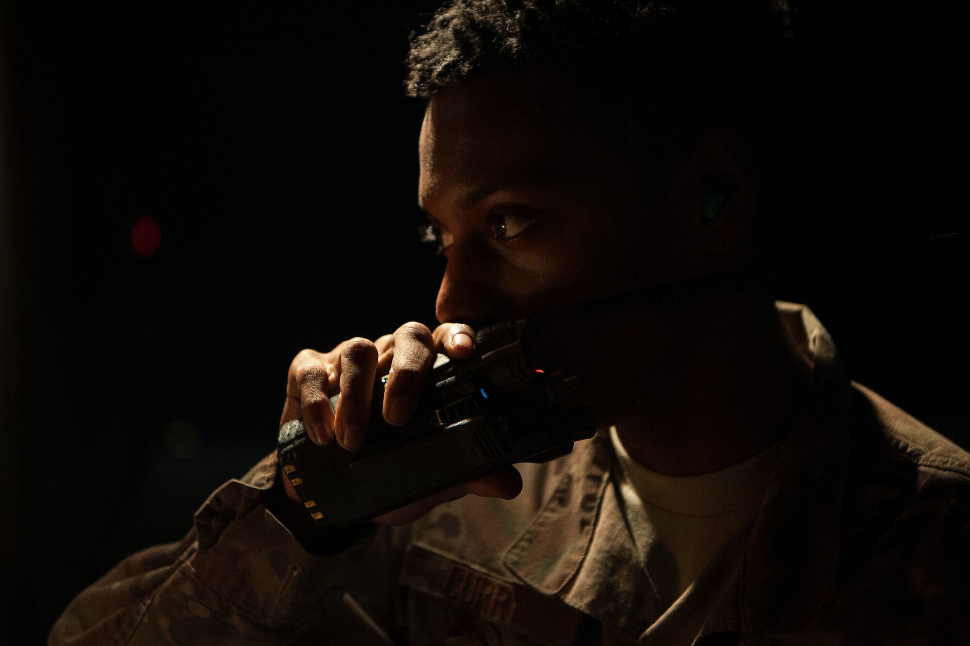 Airman 1st Class Christen Curry, 379th Expeditionary Logistics Readiness Squadron fuels distribution operator, uses his radio while refueling a C-130 Hercules Nov. 28, 2018, at Al Udeid Air Base, Qatar.