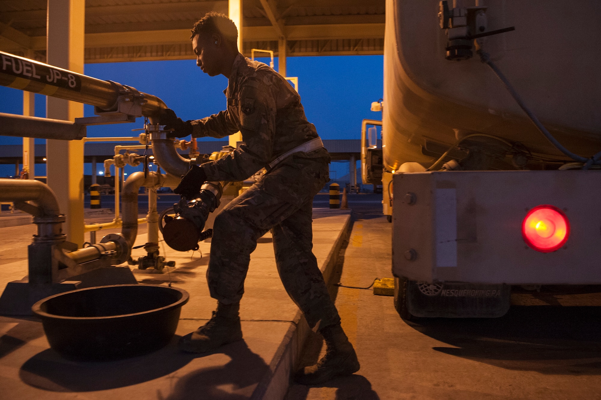 Airman 1st Class Christen Curry, 379th Expeditionary Logistics Readiness Squadron fuels distribution operator, fills the tank of a truck with jet fuel Nov. 28, 2018, at Al Udeid Air Base, Qatar.