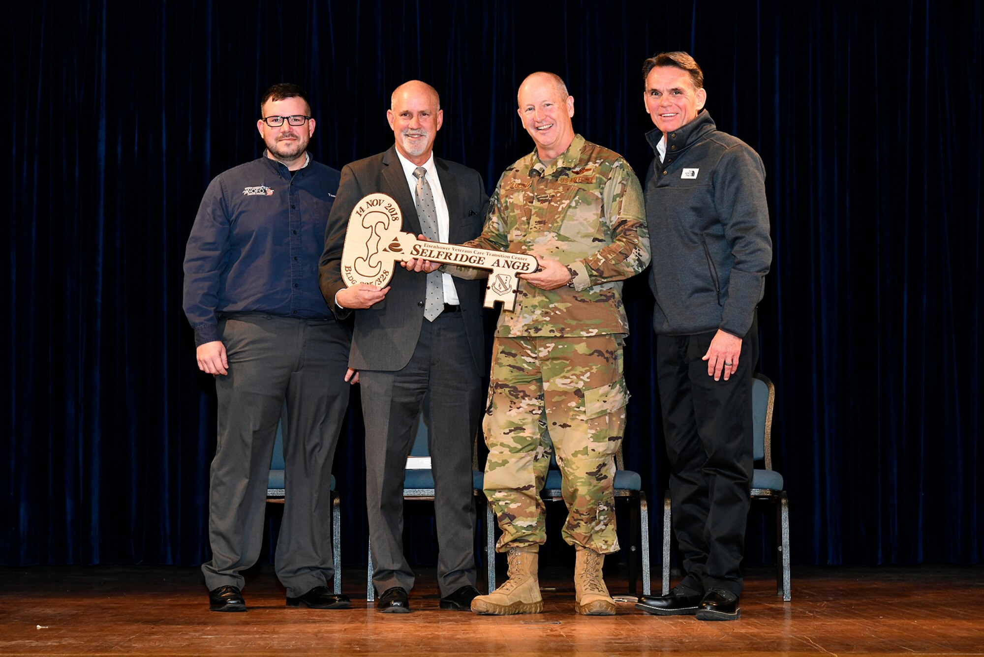 Tom Jones, a former Eisenhower patient, Brig. Gen. John D. Slocum, commander of Selfridge Air National Guard Base, John Cornack, C.E.O. of the Eisenhower Center and Mark Hackel, Macomb County Executive, celebrate the ceremonial key-passing during a ceremony here on November 14, 2018. The “Eisenhower Veteran Care Transition Center” will provide a residential rehabilitation and reintegration program, ultimately capable of servicing 42 veteran patients suffering from service-related conditions, specifically post-traumatic stress disorder, mild-to-moderate traumatic brain injury or chronic traumatic encephalopathy.