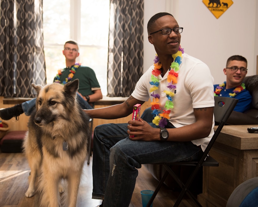 U.S. Army Pvt. Jashun Coleman, 128th Aviation Brigade Advanced Individual Training student, pets Orion in Newport News, Virginia, Nov. 22, 2018.