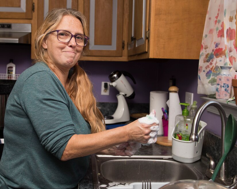 Andrea Stalnik washes dishes after Thanksgiving dinner in Newport News, Virginia, Nov. 22, 2018.