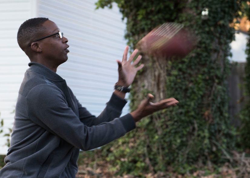 U.S. Army Pvt. Jashun Coleman, 128th Aviation Brigade Advanced Individual Training student, catches a football in Newport News, Virginia, Nov. 22, 2018.