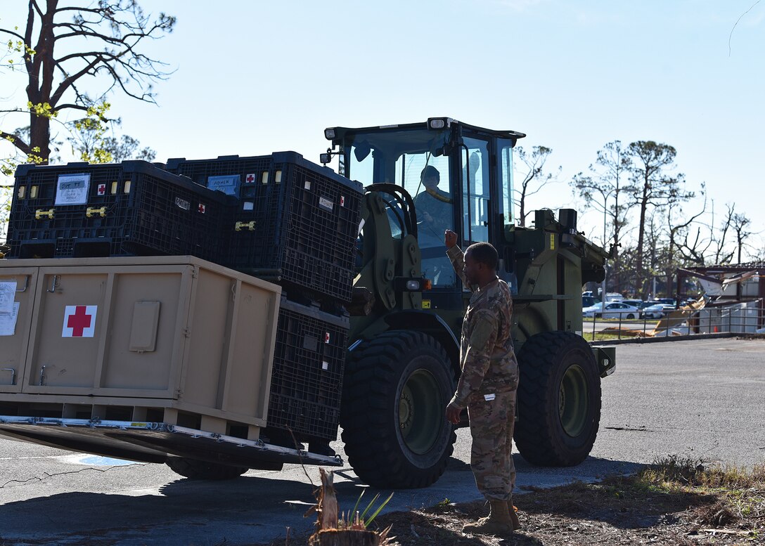 Staff Sgt. Dock Newell, 325th Medical Support Squadron medical material noncommissioned officer in charge, directs Airman Christian Myers, 1st Special Operations Logistics Readiness Squadron vehicle operator, where to stage a pallet of outpatient medical equipment at Tyndall Air Force Base, Fla., Nov. 27, 2018. Large-scale recovery efforts have continued in the weeks since Hurricane Michael struck the Florida panhandle and Tyndall AFB. (U.S. Air Force photo by Senior Airman Isaiah J. Soliz)