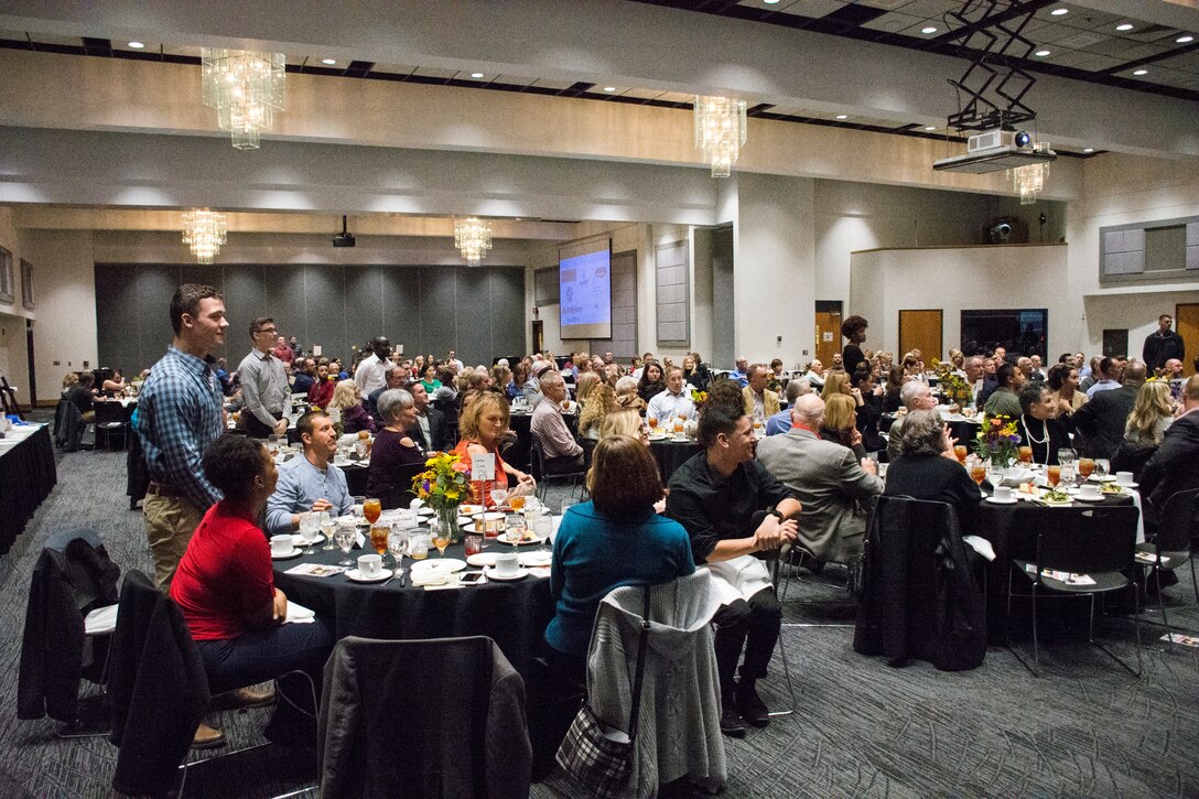 As their names are called, Airmen who applied for the Whiteman Base Community Council's Home for the Holidays program stand at the innaugural Bomber Ball Nov. 16, 2018, at the University of Central Missouir's Elliot Ballroom in Warrensburg, Mo. After the Airmen had all been called, Karl Kramer, the BCC president, informed them they had all been selected. (U.S. Air Force photo by Tech. Sgt. Bob Jennings)