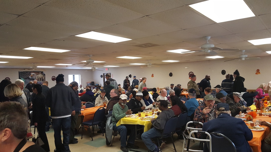 Veterans and military share a Thanksgiving meal together in a cafeteria style setting