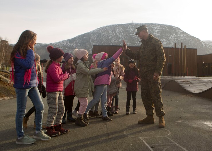 U.S. Marine Staff Sgt. Abraham Blocker with 4th Civil Affairs Group, 4th Marine Division, greets children at a local school during Exercise Trident Juncture 18 in Oppdal, Norway on Nov. 7, 2018. Trident Juncture 18 enhances the U.S. and NATO Allies’ and partners’ abilities to work together collectively to conduct military operations under challenging conditions. (U.S. Marine Corps photo by Cpl. Justin X. Toledo)