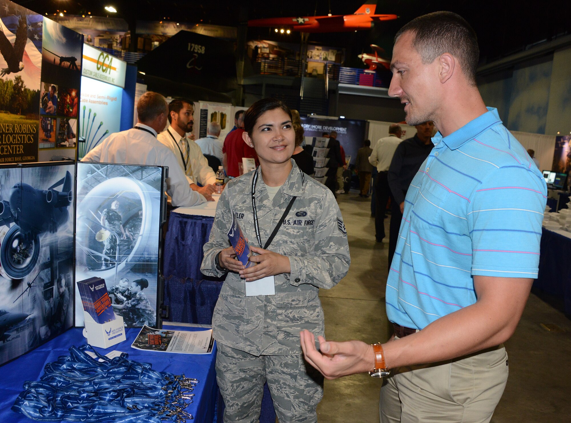 Staff Sgt. Kristine Butler, a recruiter with the 94th Airlift Wing, Dobbins Air Reserve Base, Georgia, talks to a perspective recruit at a trade show.