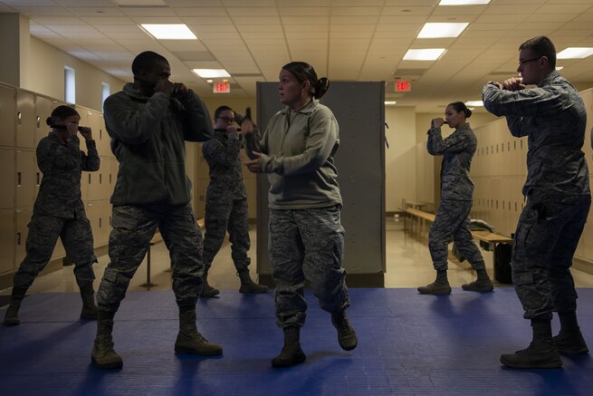 Tech. Sgt. Alexa Ormsby, 375th Security Forces Squadron operations non-commissioned officer, instructs students on the proper stance for baton strikes during a practical training session at Scott Air Force Base, Illinois, Nov. 19, 2018. Every security forces member must demonstrate proper technique during a live training scenario before being certified on the baton. (U.S. Air Force photo by Senior Airman Daniel Garcia)