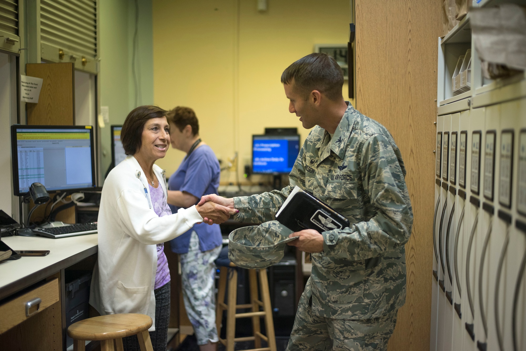 A volunteer at MacDill's Brandon Clinic greets U.S. Air Force Col. Stephen Snelson, 6th Air Mobility Wing Commander, Oct. 11, 2018